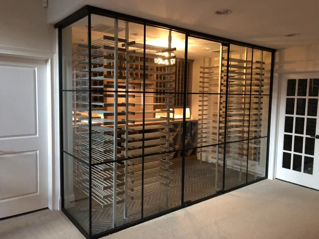 Warmly lit glass wine cellar in a modern home